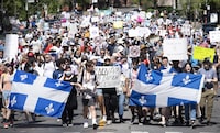 People take part in a demonstration against Bill 96 in Montreal, Saturday, May 14, 2022. The English Montreal School Board says it will file a motion in Quebec Superior Court seeking a stay on a provision in the province's French language charter that requires the use of French in the majority of the English board's internal communications. THE CANADIAN PRESS/Graham Hughes