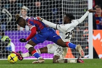 Manchester United's English defender Aaron Wan-Bissaka (R) tackles Crystal Palace's Ivorian striker Wilfried Zaha (L) as he runs with the ball towards the goal during the English Premier League football match between Crystal Palace and Manchester United at Selhurst Park in south London on January 18, 2023. (Photo by ADRIAN DENNIS / AFP) / RESTRICTED TO EDITORIAL USE. No use with unauthorized audio, video, data, fixture lists, club/league logos or 'live' services. Online in-match use limited to 120 images. An additional 40 images may be used in extra time. No video emulation. Social media in-match use limited to 120 images. An additional 40 images may be used in extra time. No use in betting publications, games or single club/league/player publications. /  (Photo by ADRIAN DENNIS/AFP via Getty Images)