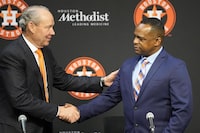 Houston Astros owner Jim Crane, left, shakes hands with Dana Brown during a news conference after Brown was hired as the Astros general manager Thursday, Jan. 26, 2023, in Houston. Brown replaces James Click, who was not given a new contract and parted ways with the Astros just days after they won the World Series. (AP Photo/David J. Phillip)