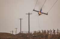 FILE - A telephone pole burns from the Smokehouse Creek Fire, Feb. 28, 2024, in Canadian, Texas. The utility provider Xcel Energy said Thursday, March 7, 2024 that its facilities appeared have played a role in igniting a massive wildfire in the Texas Panhandle that grew to the largest blaze in state history. (AP Photo/David Erickson, file)