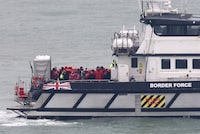 FILE PHOTO: People, believed to be migrants, stand on a British Border Force vessel as they arrive at Port of Dover, Dover, Britain, January 17, 2024. REUTERS/Toby Melville/File Photo
