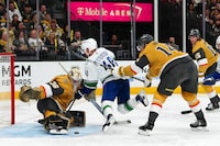Apr 2, 2024; Las Vegas, Nevada, USA; Vancouver Canucks center Elias Pettersson (40) is checked by Vegas Golden Knights defenseman Nicolas Hague (14) as Vegas Golden Knights goaltender Logan Thompson (36) makes a save during the second period at T-Mobile Arena. Mandatory Credit: Stephen R. Sylvanie-USA TODAY Sports