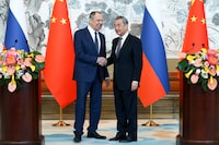In this photo released by Russian Foreign Ministry Press Service on Tuesday, April 9, 2024, Russian Foreign Minister Sergey Lavrov, left, and Chinese Foreign Minister Wang Yi shake hands after their joint news conference following the talks in Beijing, China. Russian Foreign Minister Sergey Lavrov is visiting Beijing to display the strength of ties with close diplomatic partner China amid Moscow's grinding war against Ukraine. (Russian Foreign Ministry Press Service via AP)
