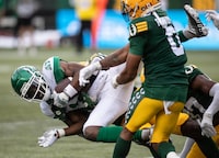 Saskatchewan Roughriders \s19 is tackled by Edmonton Elks Kai Gray (29) during first half CFL action in Edmonton, Alta., on Sunday June 11, 2023. THE CANADIAN PRESS/Jason Franson.