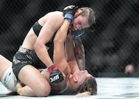 Jasmine Jasudavicius, top, fights Priscila Cachoeira during UFC 297 in Toronto on Saturday, January 20, 2024. THE CANADIAN PRESS/Nathan Denette                             