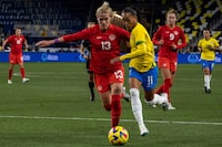 Canada's Sophie Schmidt (L) fights for the ball against Brazil's Adriana during the 2023 SheBelieves Cup women's soccer match between Canada and Brazil at Geodis Park in Nashville, Tennessee, on February 19, 2023. (Photo by SETH HERALD / AFP) (Photo by SETH HERALD/AFP via Getty Images)