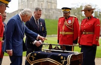 King Charles III is presented with a sword as he formally accepts the role of Commissioner-in-Chief of the Royal Canadian Mounted Police (RCMP) during a ceremony in the quadrangle at Windsor Castle, Berkshire, Britain Picture date: Friday April 28, 2023. Andrew Matthews/Pool via REUTERS