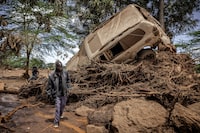 A man walks next to a damaged car in an area heavily affected by torrential rains and flash floods in the village of Kamuchiri, near Mai Mahiu, on April 29, 2024. At least 45 people died when a dam burst its banks near a town in Kenya's Rift Valley, police said on April 29, 2024, as torrential rains and floods battered the country.
The disaster raises the total death toll over the March-May wet season in Kenya to more than 120 as heavier than usual rainfall pounds East Africa, compounded by the El Nino weather pattern. (Photo by LUIS TATO / AFP) (Photo by LUIS TATO/AFP via Getty Images)