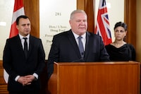 Ontario Premier Doug Ford is flanked by MPP's Michael Parsa, left, and Goldie Ghamari, during a news conference in Toronto, Thursday, Jan. 16, 2020. Most of the children in Ontario waiting for publicly funded core autism therapy will not receive it any time soon, the government says in an internal assessment obtained by The Canadian Press. Days into his new role this spring as Minister of Children, Community and Social Services, Parsa was given a transition binder with information on the files he now oversees.THE CANADIAN PRESS/Cole Burston