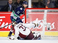 Seattle Thunderbirds forward Brad Lambert, right, scores on Peterborough Petes goalie Michael Simpson during second period semifinal CHL Memorial Cup hockey action in Kamloops, B.C., Friday, June 2, 2023.THE CANADIAN PRESS/Jeff McIntosh