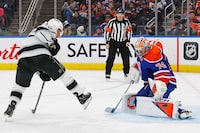 Feb 26, 2024; Edmonton, Alberta, CAN; Edmonton Oilers goaltender Stuart Skinner (74) makes a save on  on a deflection by Los Angeles Kings forward Trevor Moore (12) during the third period at Rogers Place. Mandatory Credit: Perry Nelson-USA TODAY Sports