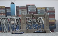 Recovery crews work near the collapsed Francis Scott Key Bridge after it was struck by the container ship Dali in Baltimore, Maryland, on March 27, 2024. Authorities in Baltimore were set to focus on expanding recovery efforts on March 27 after the cargo ship slammed into the bridge, causing it to collapse and leaving six people presumed dead. All six were members of a construction crew repairing potholes on the bridge when the structure fell into the Patapsco River at around 1:30 am (0530 GMT) on March 26. (Photo by Jim WATSON / AFP) (Photo by JIM WATSON/AFP via Getty Images)