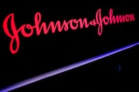 FILE PHOTO: The Johnson & Johnson logo is displayed on a screen on the floor of the New York Stock Exchange (NYSE) in New York, U.S., May 29, 2019. REUTERS/Brendan McDermid/File Photo/File Photo