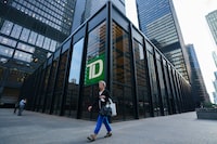 A proposed class action lawsuit has been filed against Toronto-Dominion Bank alleging it failed to pay or properly pay its mobile mortgage specialists vacation and/or public holiday pay on their commissions, volume bonuses and other variable payments. A person walks past a TD Bank sign in the financial district in Toronto on Tuesday, Sept. 20, 2022. THE CANADIAN PRESS/Alex Lupul