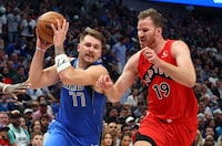 DALLAS, TEXAS - NOVEMBER 08: Luka Doncic #77 of the Dallas Mavericks drives past Jakob Poeltl #19 of the Toronto Raptors in the second quarter at American Airlines Center on November 08, 2023 in Dallas, Texas. NOTE TO USER: User expressly acknowledges and agrees that, by downloading and or using this photograph, User is consenting to the terms and conditions of the Getty Images License Agreement.  (Photo by Richard Rodriguez/Getty Images)