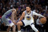 Golden State Warriors guard Stephen Curry (30) is defended by Sacramento Kings guard De'Aaron Fox (5) during the second half of Game 5 of an NBA basketball first-round playoff series Wednesday, April 26, 2023, in Sacramento, Calif. The Warriors won 123-116. (AP Photo/José Luis Villegas)