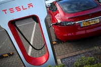 FILE PHOTO: A Tesla car is charged at a Tesla dealership in West Drayton, just outside London, Britain, February 7, 2018. REUTERS/Hannah McKay/File Photo