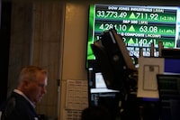A television displays market news on the floor at the New York Stock Exchange in New York, Friday, June 2.