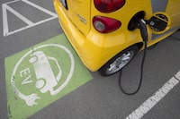 An electric car is seen getting charged at parking lot in Tsawwassen, near Vancouver B.C., on April, 6, 2018. THE CANADIAN PRESS/Jonathan Hayward
