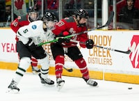 Boston defender Megan Keller (5) fights for the puck with Ottawa forward Gabbie Hughes (17) during second period PWHL hockey action in Ottawa on Wednesday, April 24, 2024. THE CANADIAN PRESS/Sean Kilpatrick