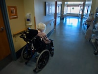 A report on the spread of COVID-19 in long-term care homes in Prince Edward Island found that the world of residents became smaller as restrictions grew, cutting them off from relationships that mattered. A resident makes her way down a hallway at a seniors residence Friday, March 12, 2021, in Laval, Quebec. THE CANADIAN PRESS/Ryan Remiorz