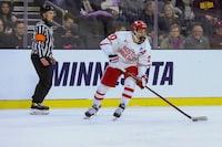 Boston University's Lane Hutson (20) looks to pass the puck during the third period of a regional final against Minnesota in the men's NCAA college hockey tournament, Saturday, March 30, 2024, in Sioux Falls, S.D. Hutson has never had any issue staying in the moment. And the defenceman's razor-sharp focus is currently on helping Boston University secure its sixth U.S. college hockey title at the NCAA Men's Frozen Four.THE CANADIAN PRESS/AP/Josh Jurgens