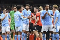 Manchester City players celebrate their victory at the English Premier League soccer match between Manchester City and Luton Town at Etihad stadium in Manchester, England, Saturday, April 13, 2024. (AP Photo/Rui Vieira)
