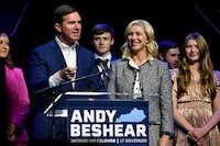 Kentucky Gov. Andy Beshear speaks during an election night rally after he was elected to a second term in Louisville, Ky., Tuesday, Nov. 7, 2023. At right is his wife Britiany Beshear. (AP Photo/Timothy D. Easley)