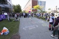 A community event takes place outside Hagey Hall to focus on supporting one another and making everyone feel safe in Waterloo, Ontario on Thursday, June 29, 2023. Several Ontario universities are removing course location and other information from their public websites as a safety measure, as faculty representatives look to be more involved in efforts to prevent harassment and hate crimes on campus. THE CANADIAN PRESS/Nicole Osborne