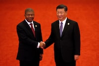 FILE PHOTO: Angola's President Joao Lourenco, left, shakes hands with Chinese President Xi Jinping during the Forum on China-Africa Cooperation held at the Great Hall of the People in Beijing September 3, 2018. Andy Wong/POOL Via REUTERS/File Photo