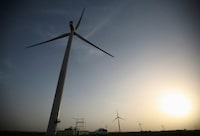 FILE PHOTO: Power generating windmill turbines are pictured during the inauguration ceremony of the new 25 MW ReNew Power wind farm at Kalasar village in the western Indian state of Gujarat May 6, 2012. REUTERS/Amit Dave (INDIA - Tags: ENERGY BUSINESS)