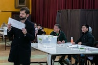 Chile's President Gabriel Boric shows his ballot prior to casting his vote during an election to choose members of a Constitutional Council who will draft a new constitution proposal, in Punta Arenas, Chile, Sunday, May 7, 2023. A first attempt to replace the current charter bequeathed by the military 42 years ago was rejected by voters during a referendum in 2022. (AP Photo/Andres Poblete)