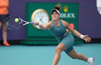 Bianca Andreescu, of Canada, returns a volley from Emma Raducanu, of Great Britain, in the first set of a match at the Miami Open tennis tournament, Wednesday, March 22, 2023, in Miami Gardens, Fla. (AP Photo/Jim Rassol)