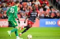 Toronto FC forward Prince Owusu, right, challenges FC Dallas goalkeeper Maarten Paes (30) during first half MLS action in Toronto, Saturday, May 4, 2024. THE CANADIAN PRESS/Christopher Katsarov
