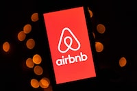 (FILES) In this file illustration picture taken on November 22, 2019, shows the logo of the online lodging service Airbnb displayed on a smartphone in Paris. - Airbnb said August 2, 2022 revenue in the recently ended quarter topped $2 billion as people shook off pandemic worries and took part in a banner travel season. (Photo by Lionel BONAVENTURE / AFP) (Photo by LIONEL BONAVENTURE/AFP via Getty Images)