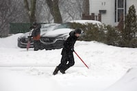 Environment Canada has issued a series of weather warnings and special weather statements as residents of New Brunswick and Newfoundland were still digging out from heavy snowfalls on the weekend. Residents clear snow from their driveways in St. John's on Friday, March 8, 2024. THE CANADIAN PRESS/Paul Daly