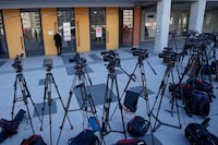 TV cameras on stand by as the media wait in front of the High Court in Belgrade, Serbia, Monday, Jan. 29, 2024. A trial started Monday in Serbia for the parents of a teenager who is accused of killing 10 people and injuring six in a mass shooting at his school last May that left the Balkan nation in shock. The suspected shooter, 13-year-old Kosta Kecmanovic, has been held in a mental institution since the attack and cannot be held criminally liable under Serbian law because of his age. His father and mother were charged with a "serious act against general safety" for failing to safeguard the weapon and ammunition used in the shooting. (AP Photo/Darko Vojinovic)