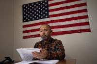 Chinese migrant Li Kai aka Khaled, an ethnic Hui Muslim, studies for a Commercial Driving License in his apartment in Flushing, New York, Friday, May 3, 2024. Li Kai came to the U.S. with his wife and two sons seeking religious freedom and a better life. The daily struggle to find work for Chinese immigrants living illegally in New York is a far cry from the picture Donald Trump and other Republicans have sought to paint about them. Asian advocacy organizations say they're concerned the exaggerated rhetoric could fuel further harassment against Asians in the U.S.  (AP Photo/Serkan Gurbuz)