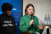 Sweden's activist Greta Thunberg (R) speaks during a session with International Energy Agency chief on the sideline of the World Economic Forum (WEF) annual meeting in Davos, on January 19, 2023. - Thunberg accused attendees of the World Economic Forum in Davos of "fuelling the destruction of the planet" as she arrived at the event in the Swiss Alps. (Photo by Fabrice COFFRINI / AFP) (Photo by FABRICE COFFRINI/AFP via Getty Images)