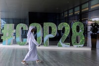 FILE PHOTO: A person walks past a "#COP28" sign in Abu Dhabi, United Arab Emirates, October 1, 2023. REUTERS/Amr Alfiky/File Photo