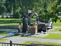 Workers reinstall a statue of Queen Elizabeth that was toppled on Canada Day 2021 on the grounds of the Manitoba legislature in Winnipeg on Friday June 2, 2023. THE CANADIAN PRESS/Steve Lambert