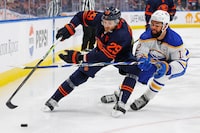 Mar 21, 2024; Edmonton, Alberta, CAN; Edmonton Oilers forward Leon Draisaitl (29) protects the puck from forward Buffalo Sabres forward Jordan Greenway (12) during the third period at Rogers Place. Mandatory Credit: Perry Nelson-USA TODAY Sports