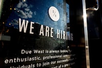 FILE PHOTO: A help wanted sign at a store along Queen Street West in Toronto Ontario, Canada June 10, 2022. REUTERS/Carlos Osorio/File Photo