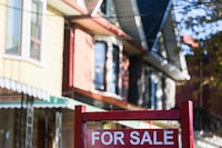 A real estate sign is displayed in front of a house in the Riverdale area of Toronto on Wednesday, September 29, 2021.&nbsp;Canada's bank regulator says it is preparing for weakness in the housing market to potentially last throughout 2023 as it flags the sector as a growing concern. THE CANADIAN PRESS/Evan Buhler