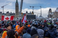 OTTAWA, ONTARIO - FEBRUARY 19: Police face off with demonstrators participating in a protest organized by truck drivers opposing vaccine mandates on Wellington St. on February 19, 2022 in Ottawa, Ontario. The drivers have used vehicles to form a blockade that has blocked several streets near Parliament Hill.  Prime Minister Justin Trudeau has invoked the Emergencies Act in an attempt to try to put an end to the demonstration that has nearly paralyzed a portion of downtown Ottawa for three weeks.  (Photo by Alex Kent/Getty Images)