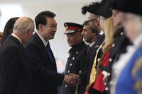 The President of Korea Yoon Suk Yeol, second left shakes hands with James Cleverly, the British Home Secretary, 4th right, during there Ceremonial Welcome, watched by Britain's King Charles at Horse Guards Parade in London, Tuesday, Nov. 21, 2023. The President of Korea Yoon Suk Yeol is on a four-day State visit to Britain.(AP Photo/Frank Augstein, Pool)
