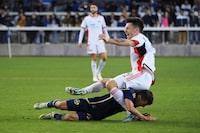 San Jose Earthquakes forward Preston Judd (19) is tackled by Vancouver Whitecaps FC midfielder Andres Cubas (20) during the second half at PayPal Park.