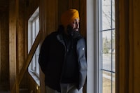 Sikh activist Inderjeet Singh Gosal, stands next to a window with a bullet hole, at a housing project of his, in Brampton, Ont., Wednesday Feb. 14, 2024. (Christopher Katsarov/The Globe and Mail). 
