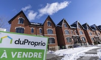 A "for sale" sign on a new housing development in Lasalle, a borough of Montreal, Monday, Feb. 19, 2024. THE CANADIAN PRESS/Christinne Muschi