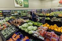 A customer walks through the produce section at a grocery store In Toronto on Friday, Feb. 2, 2024. A new report predicts that grocery inflation will fall below two per cent by the spring and stay roughly between one and two per cent for the rest of 2024. THE CANADIAN PRESS/Cole Burston